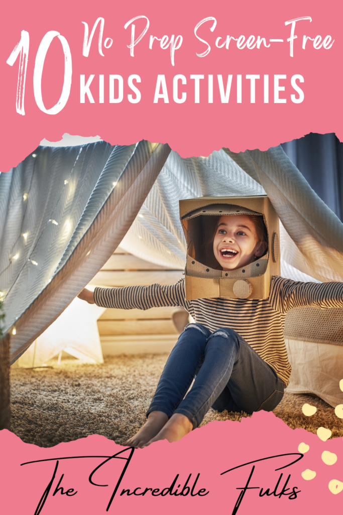 10 No prep screen-free activities for kids. This image contains a little girl inside a blanket fort wearing a space helmet made from cardboard. There are twinkle lights hung over the fort. 