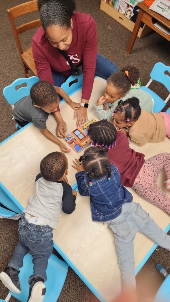 kids in a circle around a table